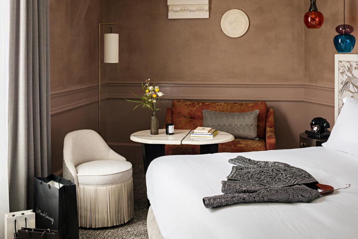 Un ou plusieurs lits dans un hébergement de l'établissement Sofitel Le Scribe Paris Opera