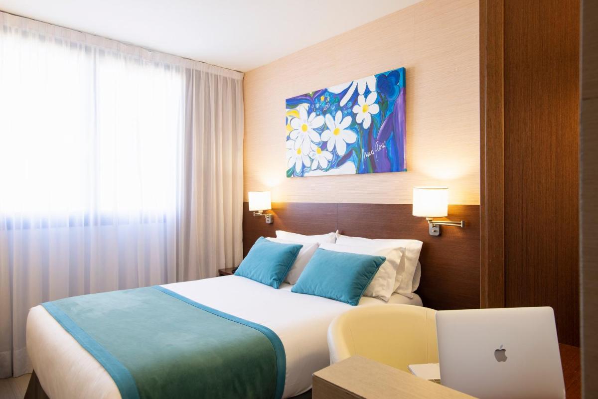 Cama o camas de una habitación en Hotel & Spa Real Ciudad De Zaragoza