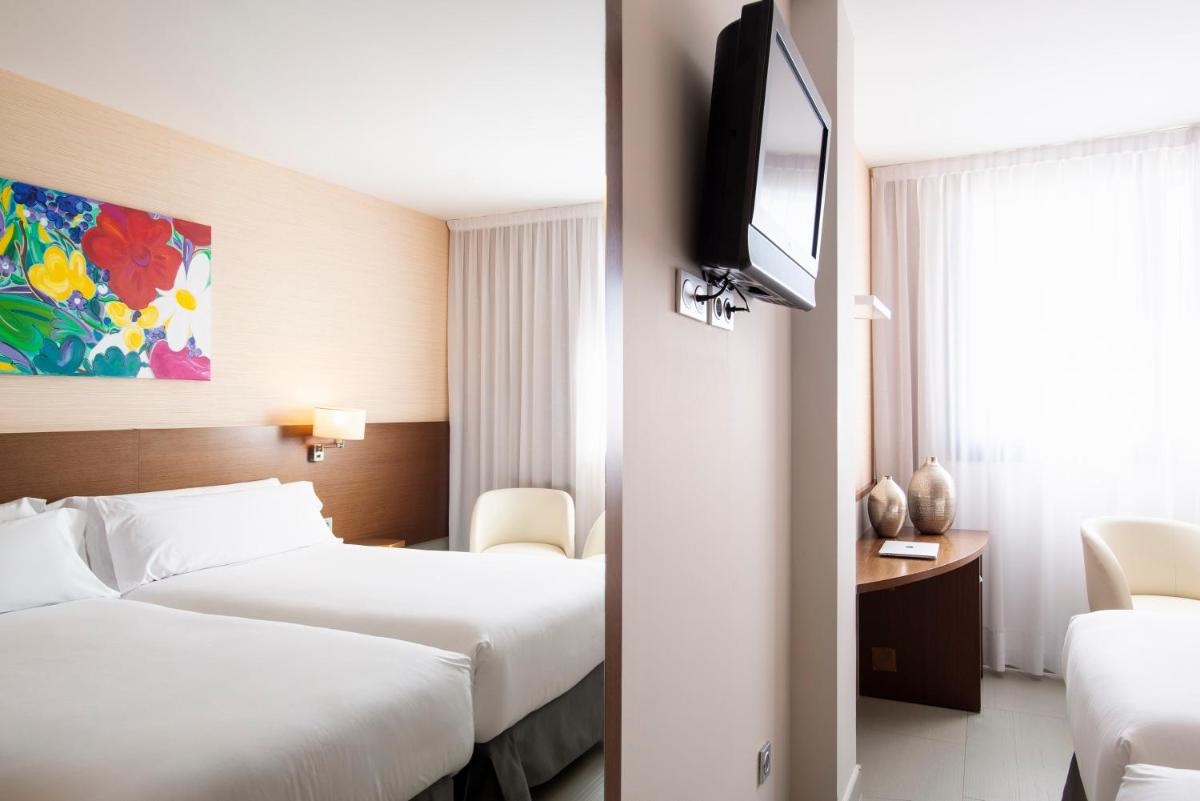 Cama o camas de una habitación en Hotel & Spa Real Ciudad De Zaragoza
