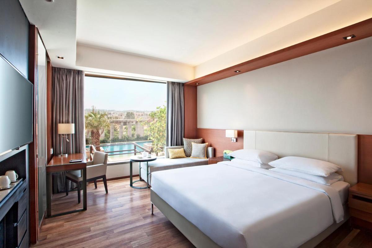 a bedroom with a large white bed and a desk at Hyatt Regency Amritsar Hotel & Spa in Amritsar