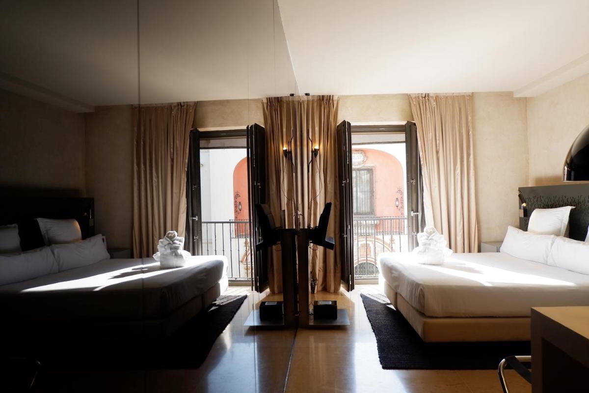 Cama o camas de una habitación en EME Catedral Mercer Hotel