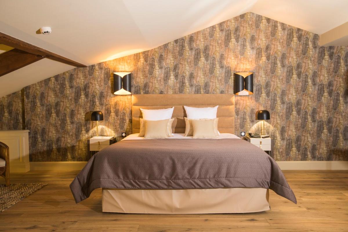 Un ou plusieurs lits dans un hébergement de l'établissement Hotel Clos Castel Villas Spa