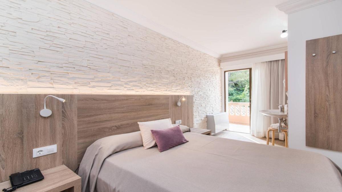 Cama o camas de una habitación en Hotel Na Taconera