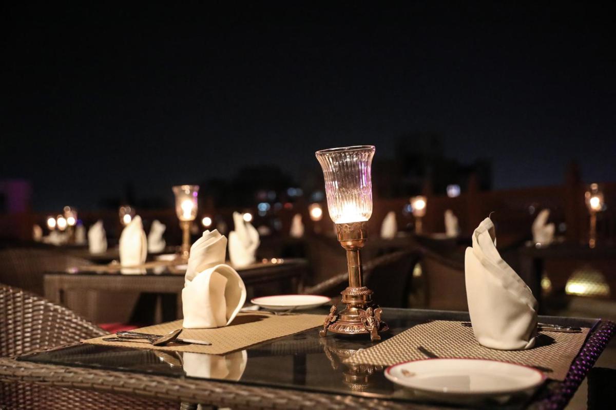 a table with a wine glass and napkins on a table at Shahpura House in Jaipur