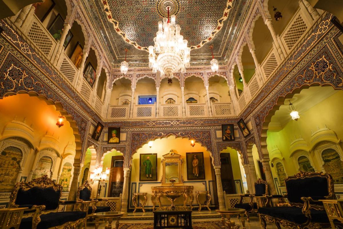 a large room with a chandelier in a building at Shahpura House in Jaipur