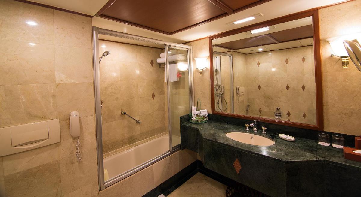 a bathroom with a sink and a shower at The Orchid Hotel Mumbai Vile Parle in Mumbai