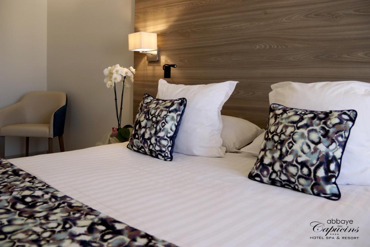 Un ou plusieurs lits dans un hébergement de l'établissement Abbaye des Capucins Spa & Resort