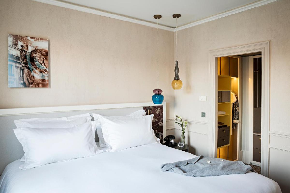 Un ou plusieurs lits dans un hébergement de l'établissement Sofitel Le Scribe Paris Opera