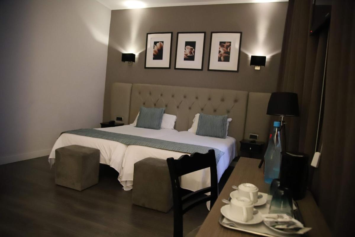 Uma cama ou camas num quarto em Hotel Bienestar Termas De Vizela