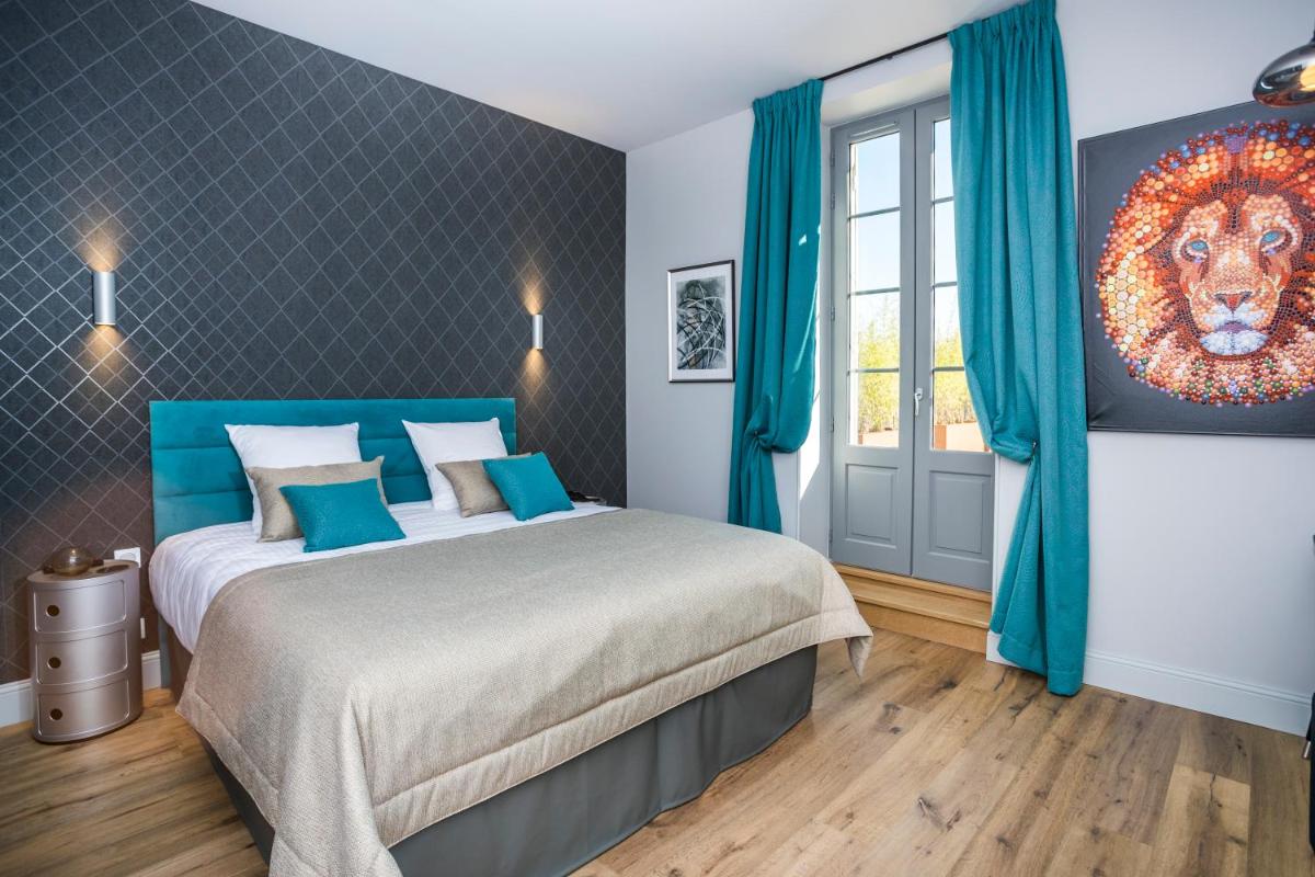 Un ou plusieurs lits dans un hébergement de l'établissement Hotel Clos Castel Villas Spa