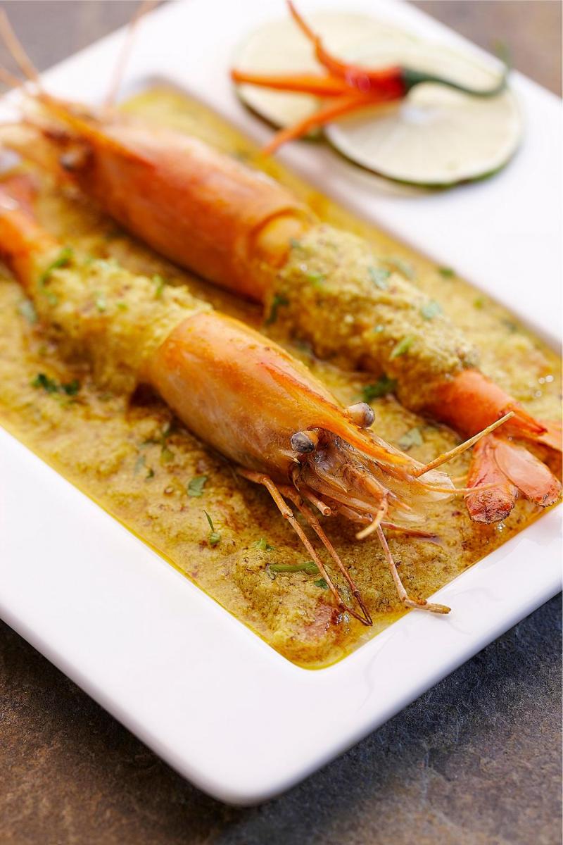 a plate of food with carrots on a table at Vivanta Kolkata EM Bypass in Kolkata
