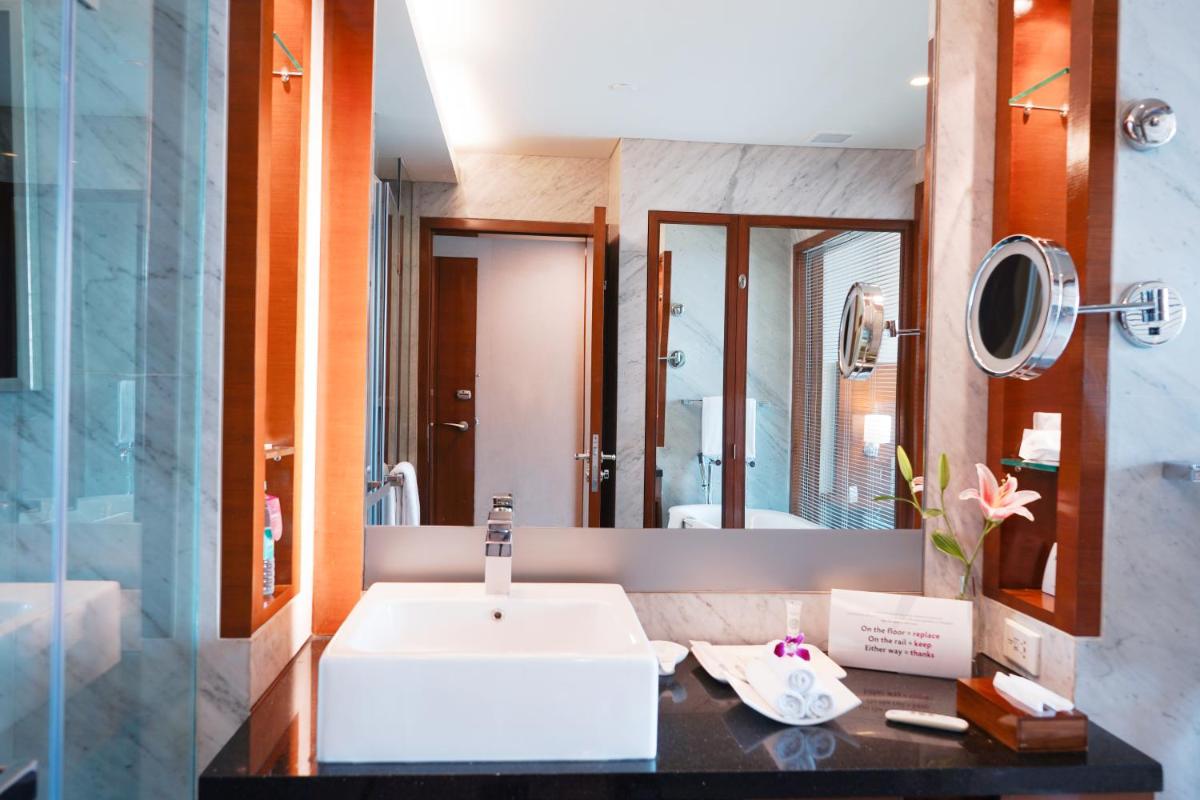 a bathroom with a sink and a mirror at Crowne Plaza Today Gurugram by IHG in Gurgaon