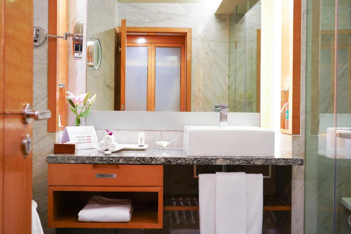 a bathroom with a sink and a mirror at Crowne Plaza Today Gurugram by IHG in Gurgaon