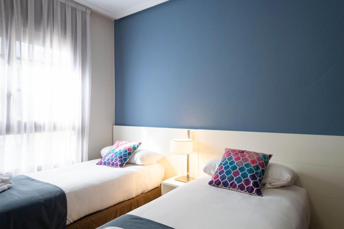 Cama o camas de una habitación en Aparthotel Los Girasoles