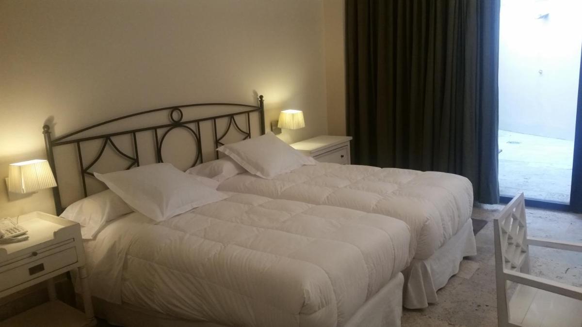 Cama o camas de una habitación en Hotel Palacio de Mengibar