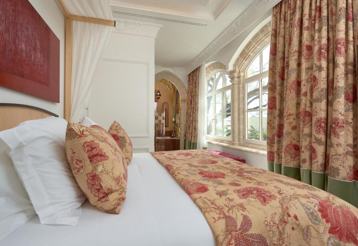 Cama o camas de una habitación en Hotel Casa Palacio María Luisa