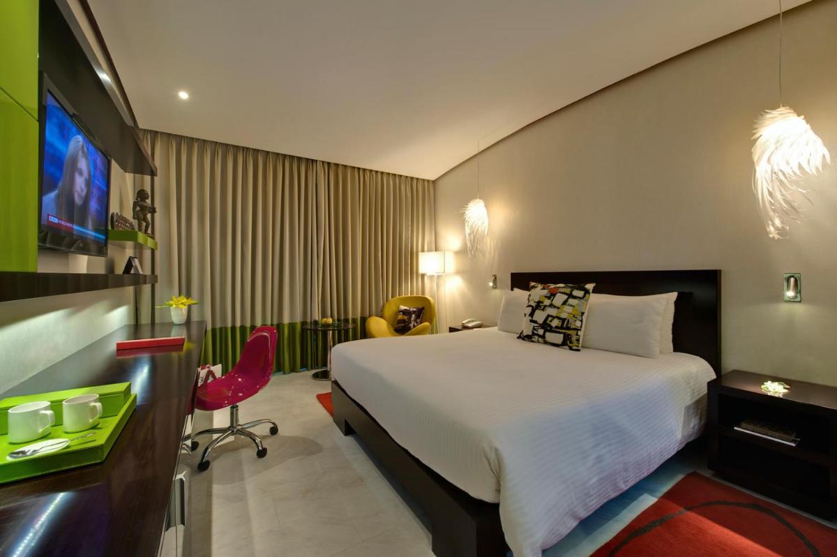 a hotel room with a bed and a tv at The Park Chennai in Chennai a hotel room with a bed and a tv at The Park Chennai in Chennai