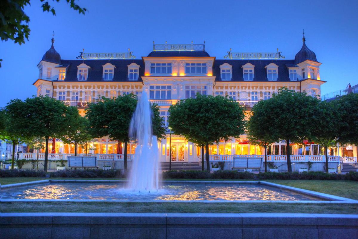 ein Gebäude mit einem Brunnen davor in der Unterkunft SEETELHOTEL Ahlbecker Hof das elegante Traditionshotel & ruhiger Rückzugsort an der Ostsee in Ahlbeck