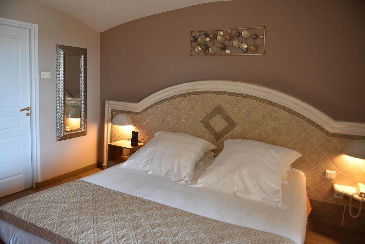 Un ou plusieurs lits dans un hébergement de l'établissement Ostella Spa & Resort