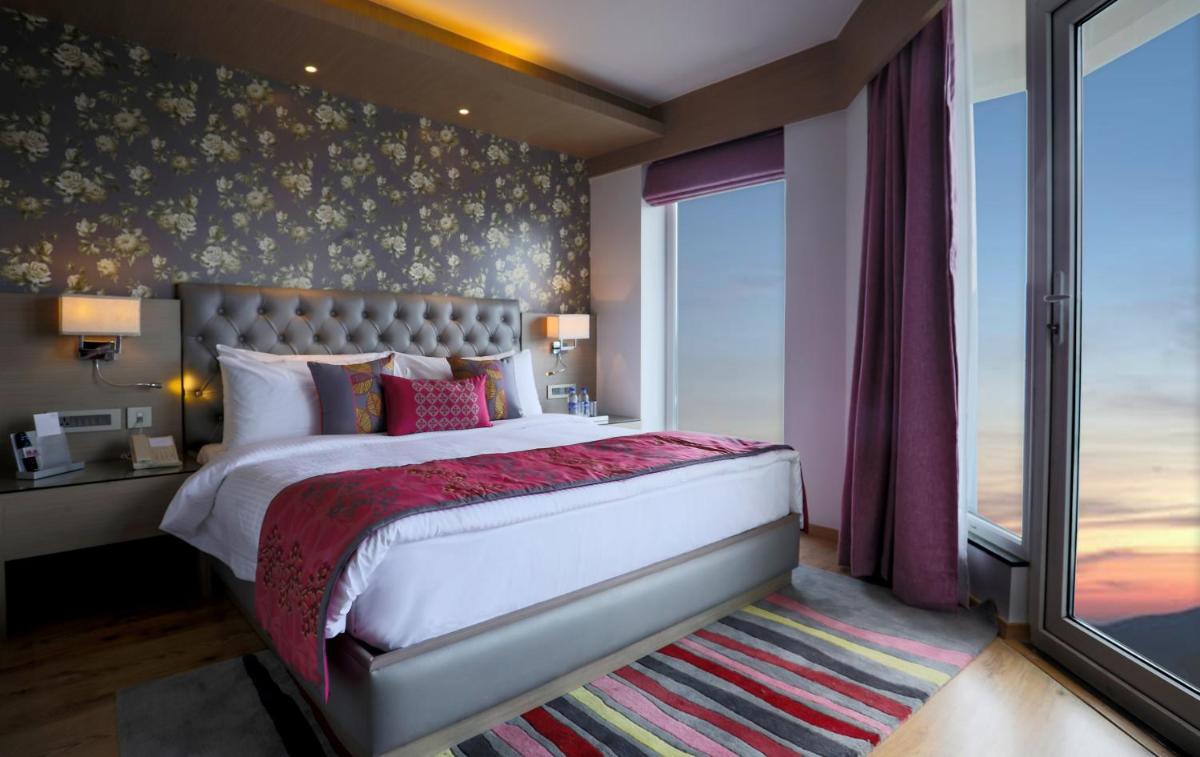 a bedroom with a large bed and a window at Welcomhotel by ITC Hotels, Shimla in Shimla