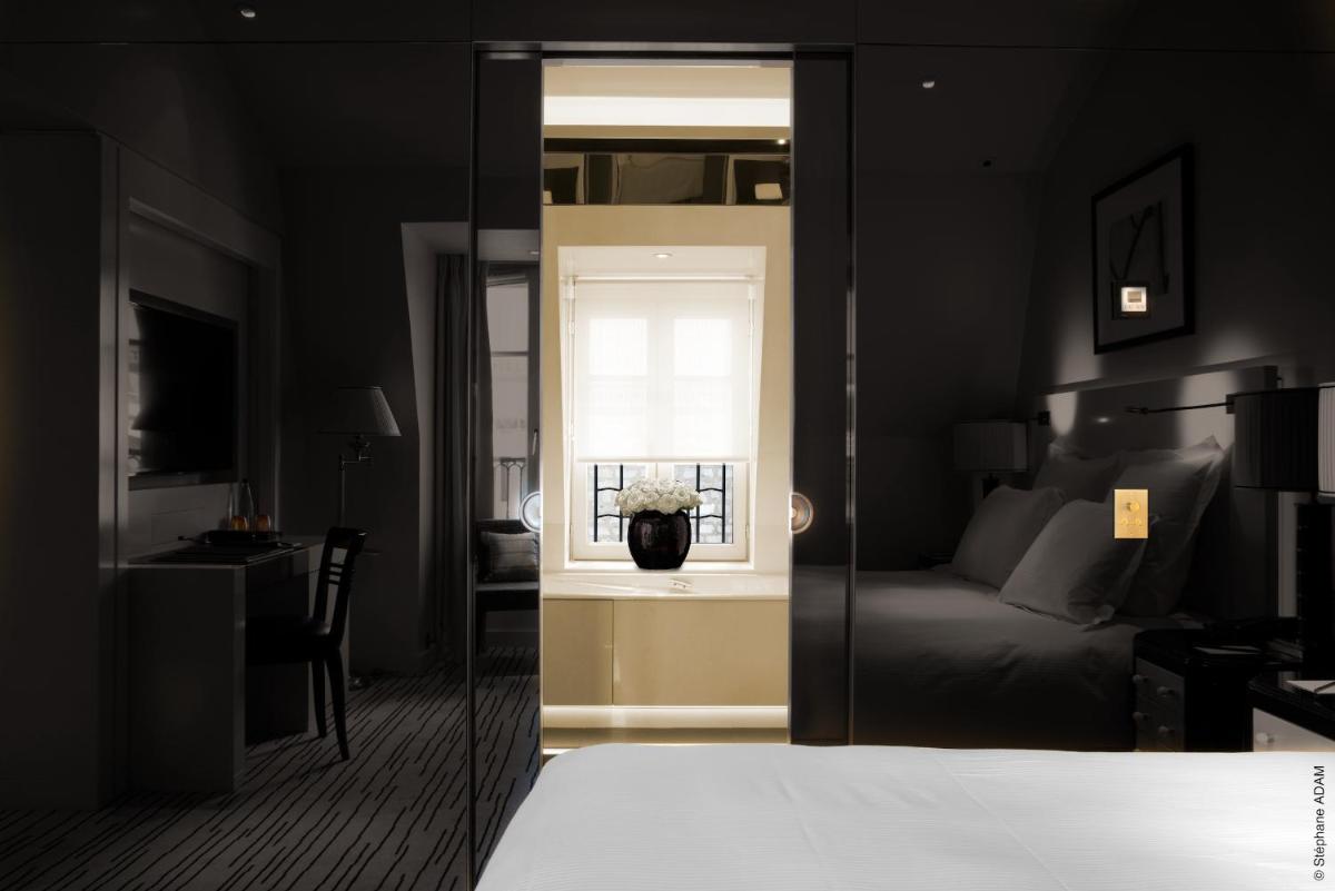 Un ou plusieurs lits dans un hébergement de l'établissement Hotel Montaigne