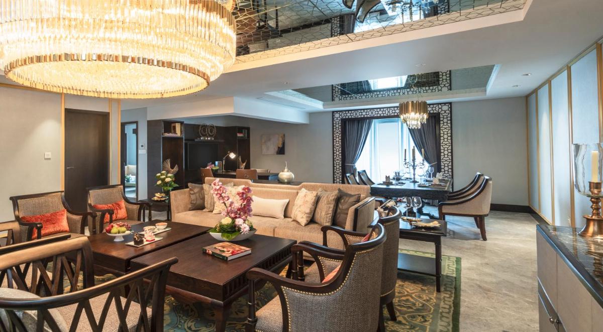 a living room with a couch and a table at Taj Coromandel in Chennai
