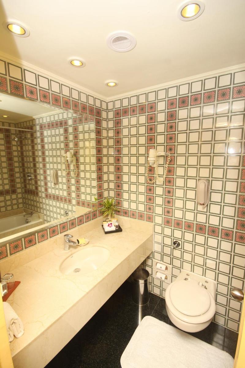 a bathroom with a toilet and a sink at Taj Bengal in Kolkata