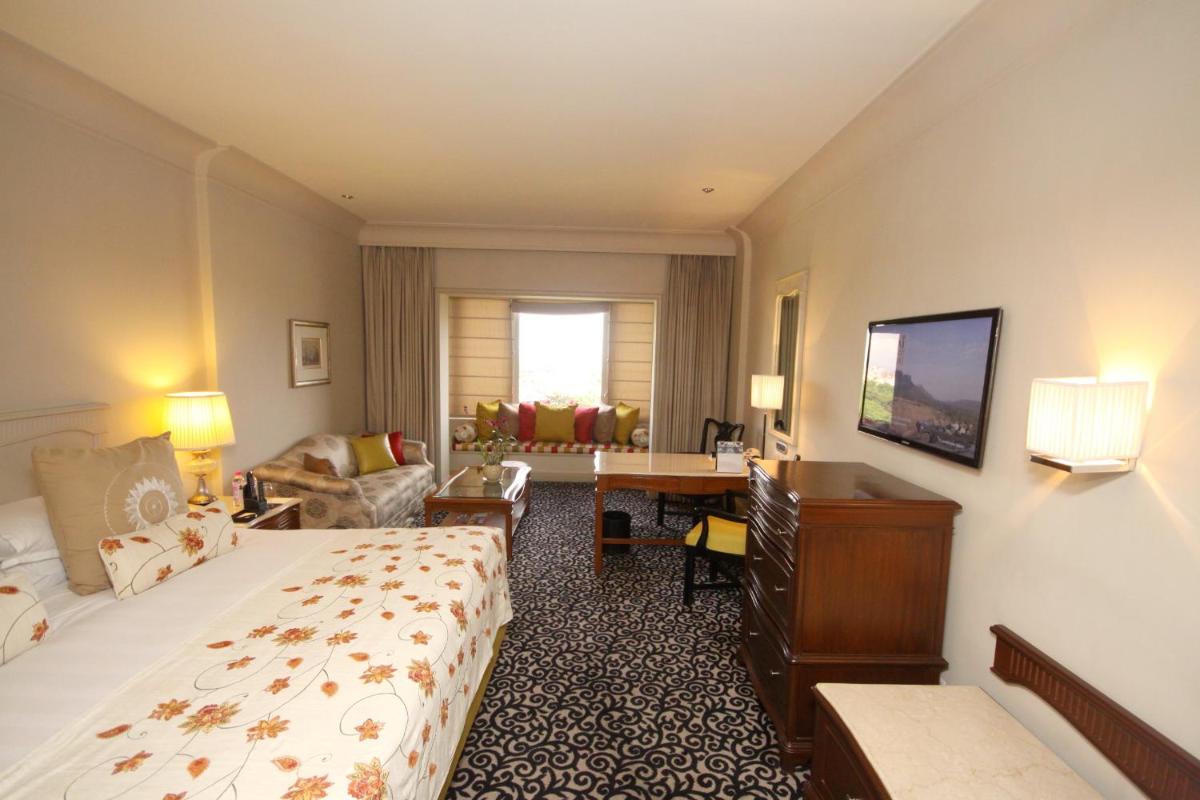 a hotel room with a bed and a desk at Taj Bengal in Kolkata