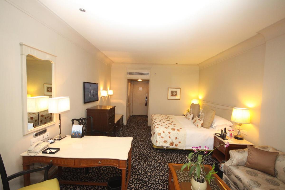 a hotel room with a bed and a desk at Taj Bengal in Kolkata