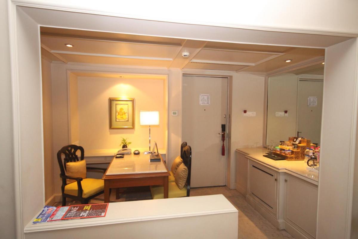 a kitchen and dining room with a table and a dining room at Taj Bengal in Kolkata