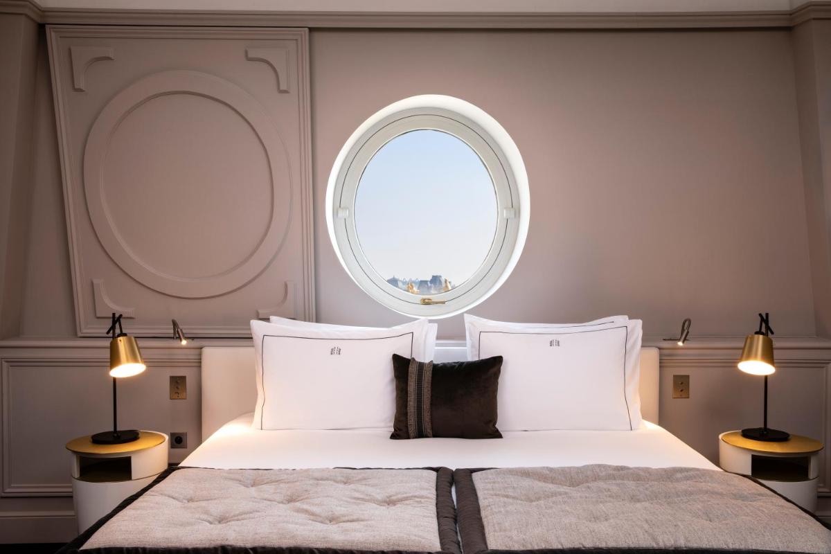 Un ou plusieurs lits dans un hébergement de l'établissement Le Damantin Hôtel & Spa