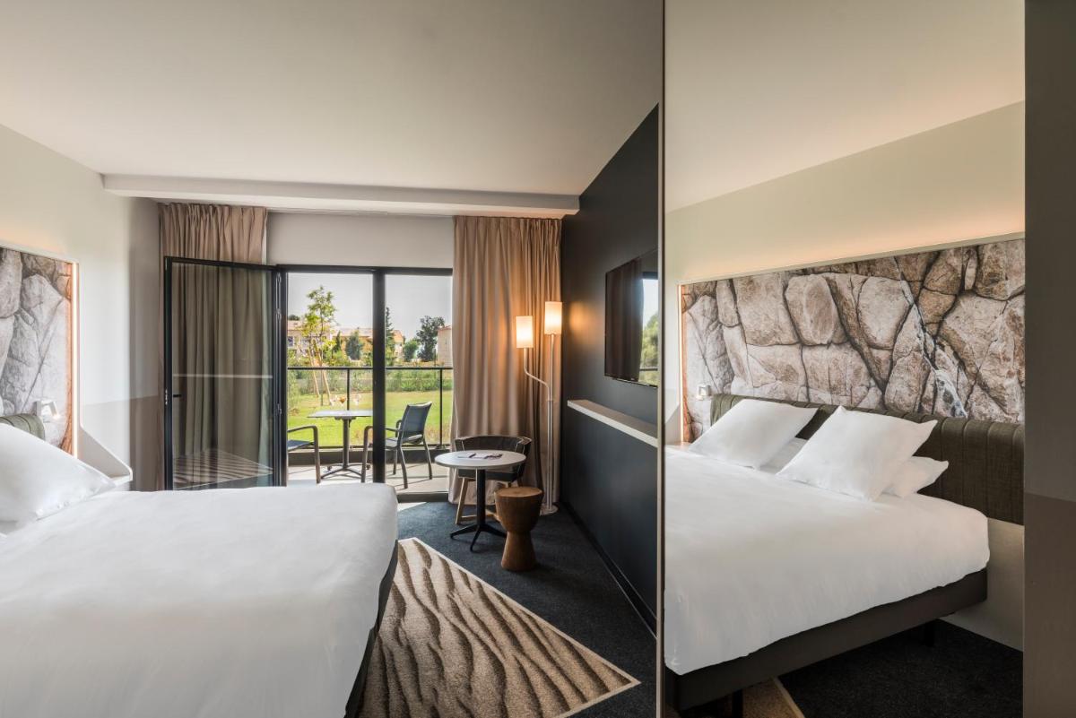 Un ou plusieurs lits dans un hébergement de l'établissement Mercure Hotel & Spa Bastia Biguglia