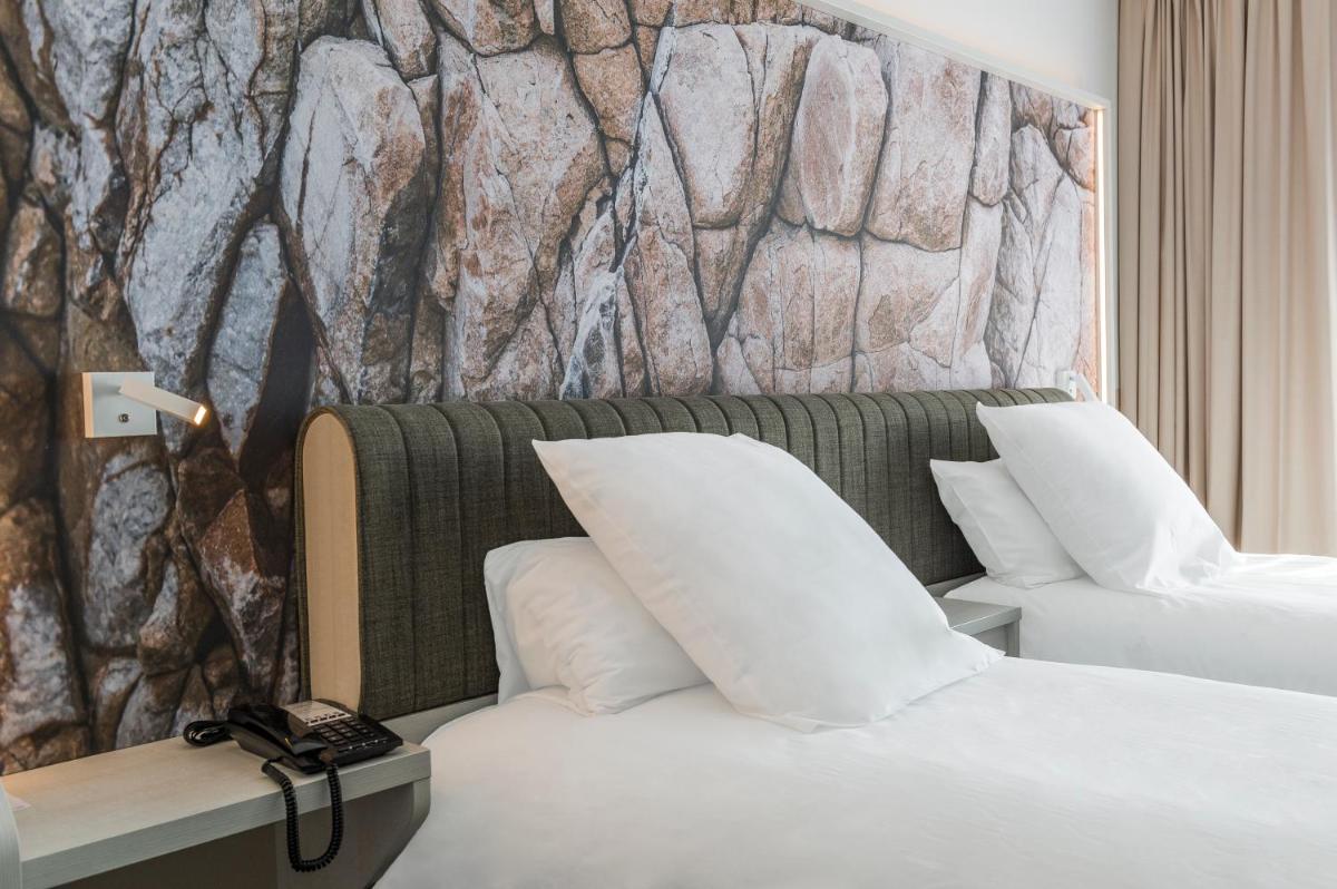 Un ou plusieurs lits dans un hébergement de l'établissement Mercure Hotel & Spa Bastia Biguglia