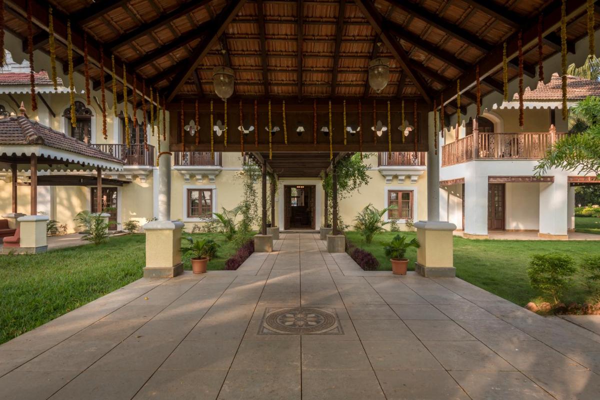 an empty courtyard of a building with a wooden ceiling at The Postcard Cuelim, Goa in Cansaulim