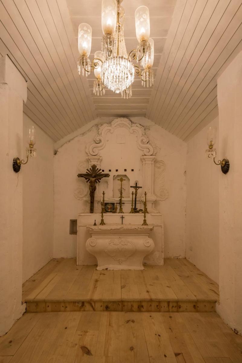 a large bathroom with a sink and a chandelier at The Postcard Cuelim, Goa in Cansaulim