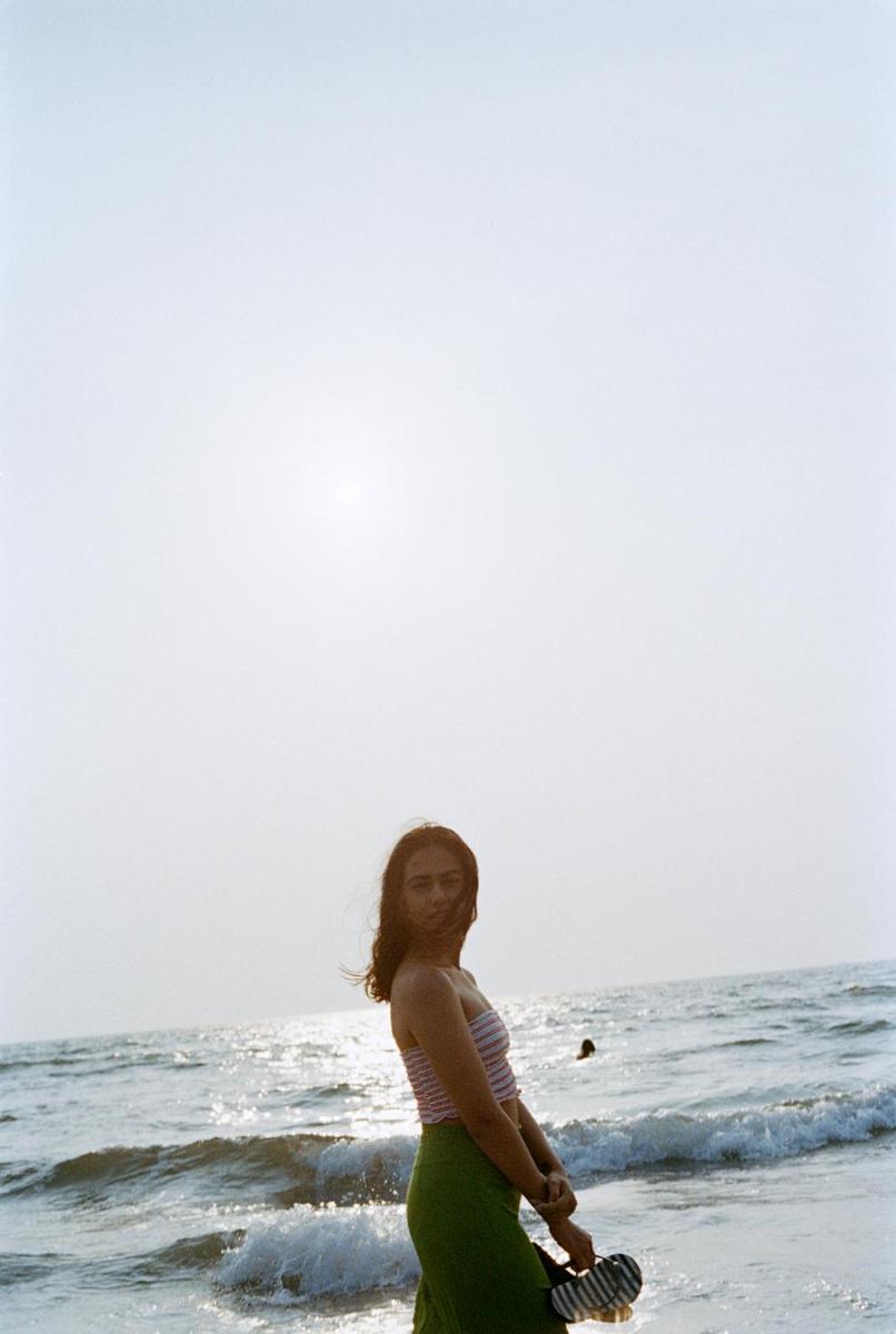 a woman standing on the beach near the ocean at The Postcard Cuelim, Goa in Cansaulim
