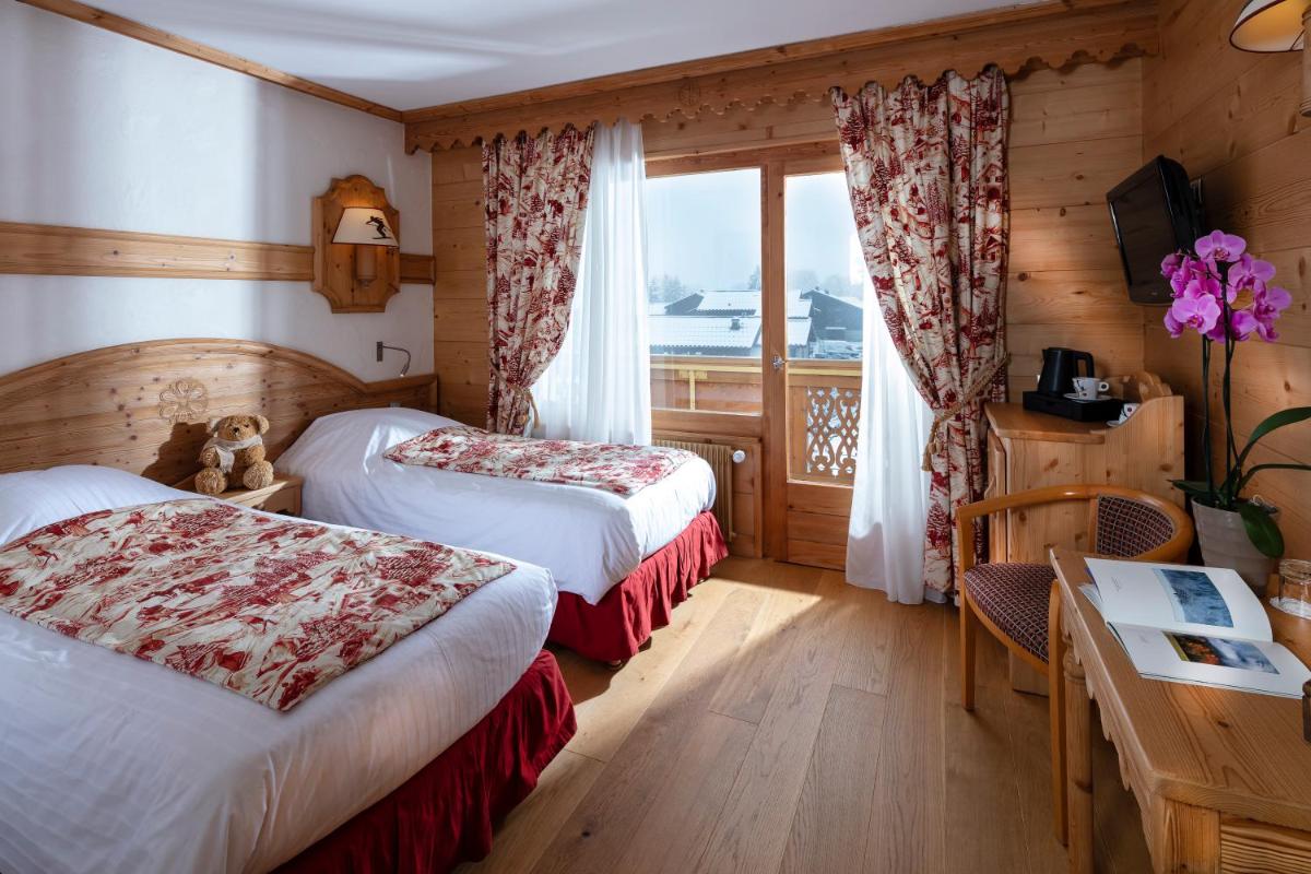 Un ou plusieurs lits dans un hébergement de l'établissement Chalet-Hôtel Neige et Roc, The Originals Relais