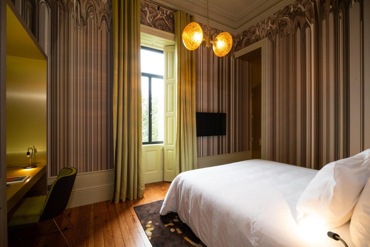 Uma cama ou camas num quarto em Vila Foz Hotel & SPA - member of Design Hotels