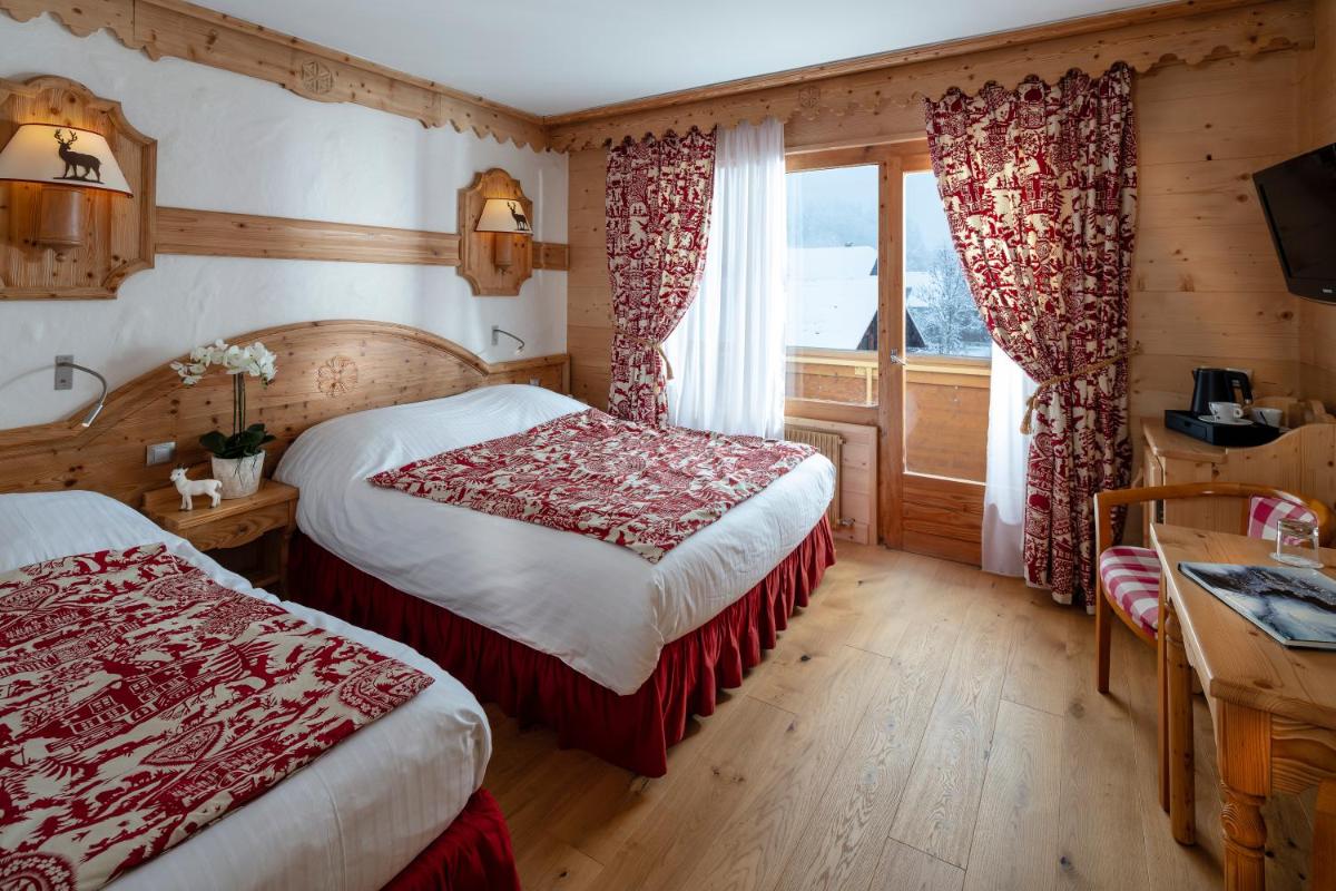 Un ou plusieurs lits dans un hébergement de l'établissement Chalet-Hôtel Neige et Roc, The Originals Relais