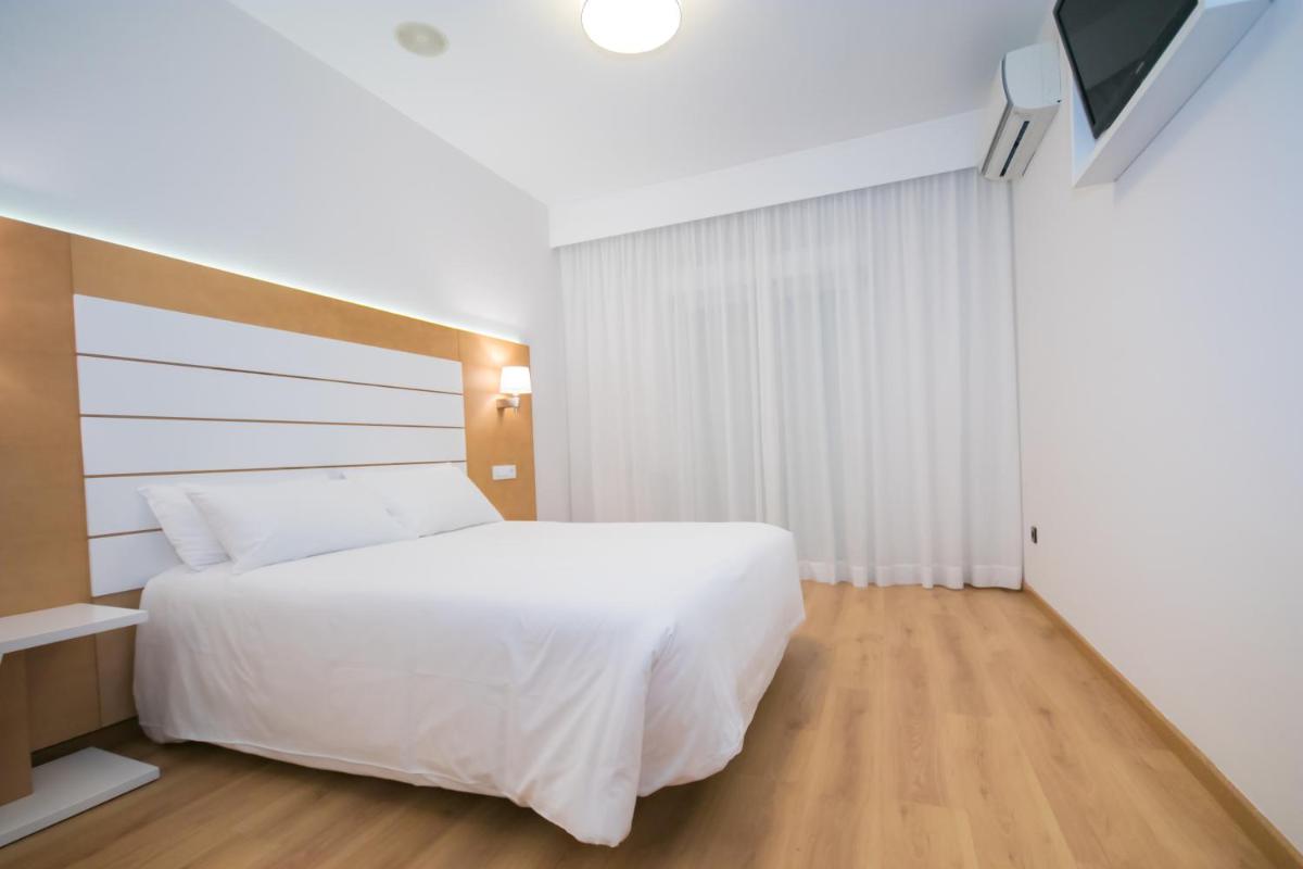 Cama o camas de una habitación en Hotel Spa Nanin Playa