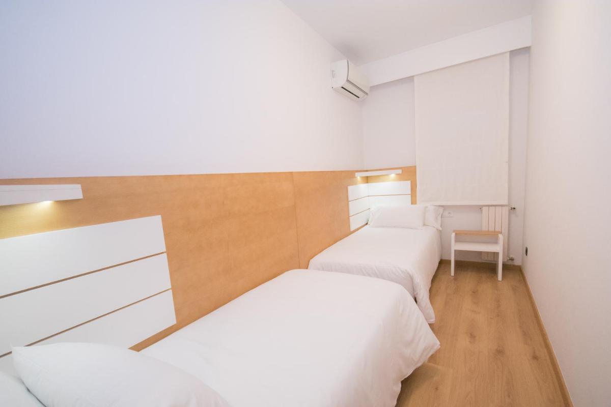 Cama o camas de una habitación en Hotel Spa Nanin Playa