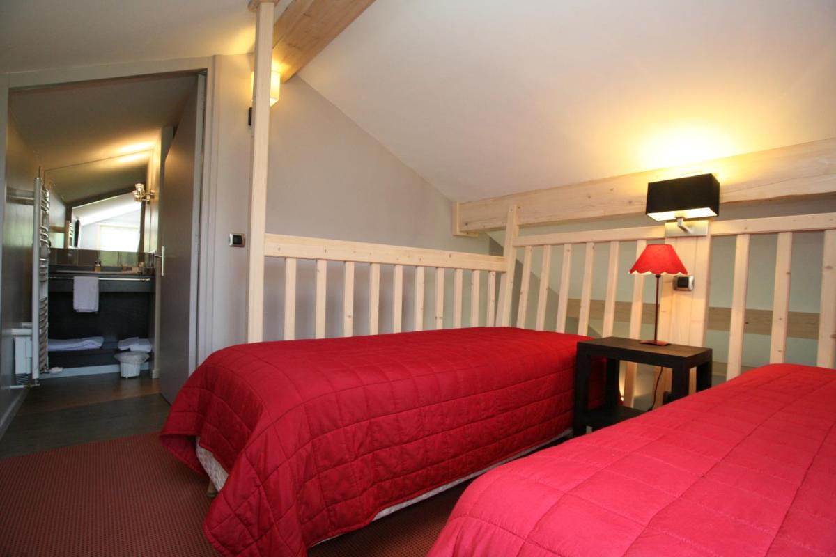 Un ou plusieurs lits dans un hébergement de l'établissement Hotel Corrieu