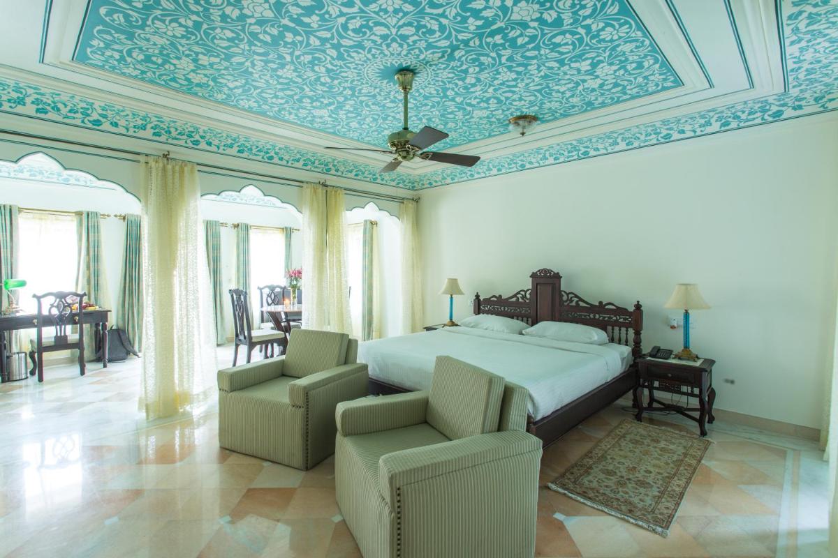 a bedroom with a bed with a blue ceiling at Royal Heritage Haveli - By Leisure Hotels in Jaipur +82 photos