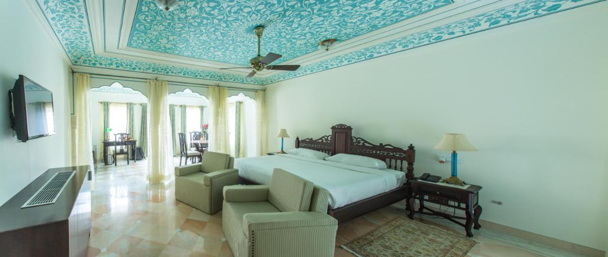 a bedroom with a bed with a blue and white ceiling at Royal Heritage Haveli - By Leisure Hotels in Jaipur