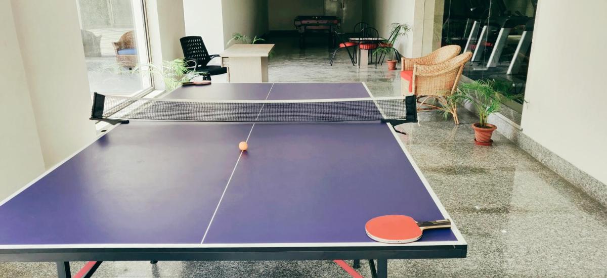 two ping pong tables in a room at Ramada by Wyndham Lucknow Hotel and Convention Center in Lucknow