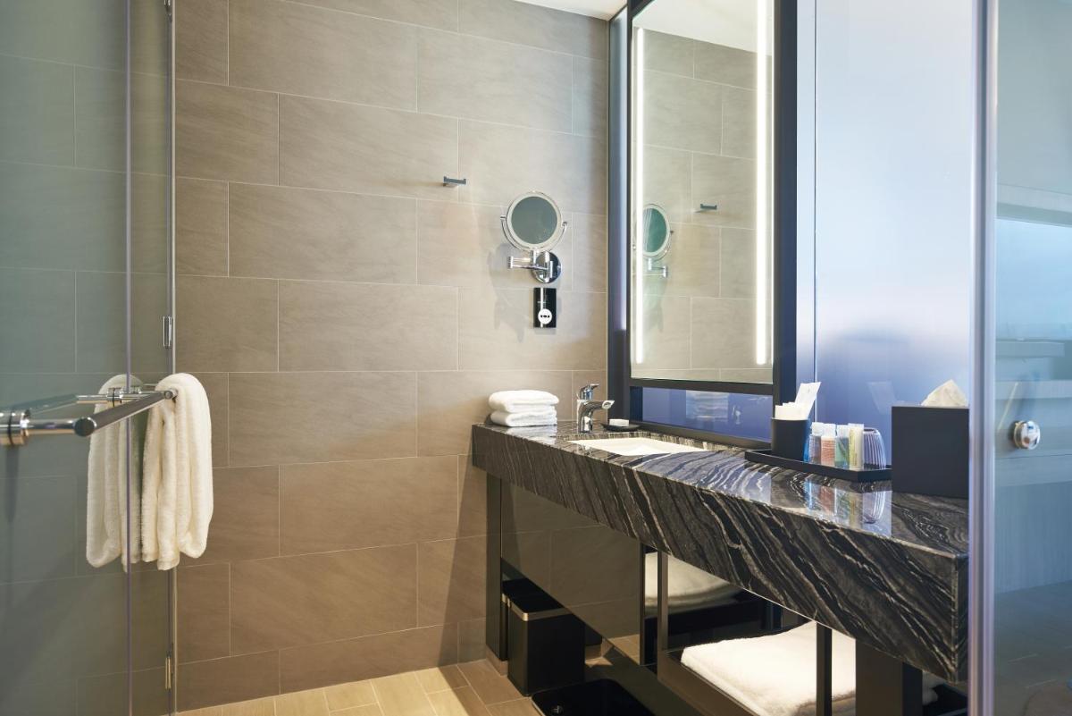 a bathroom with a sink and a shower at Capri by Fraser China Square, Singapore in Singapore