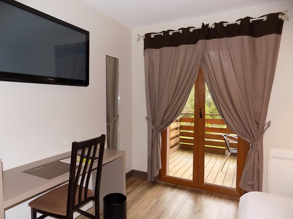 Un ou plusieurs lits dans un hébergement de l'établissement Logis Hôtel Le Régal & Spa