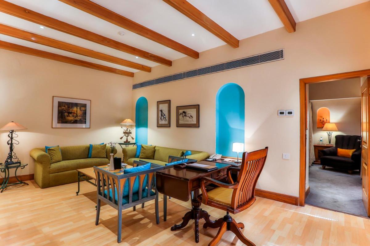 a living room with a couch and a table at Sun-n-Sand Mumbai Juhu Beach in Mumbai