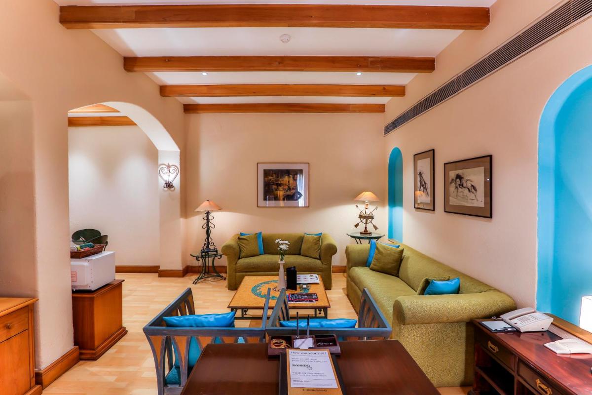 a living room with a couch and a table at Sun-n-Sand Mumbai Juhu Beach in Mumbai