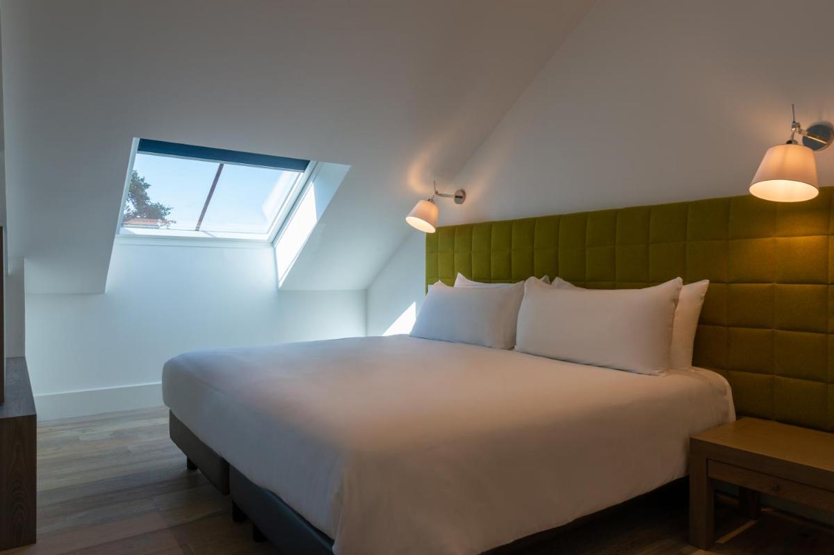 Un ou plusieurs lits dans un hébergement de l'établissement Hôtel Ginkgo - SPA Biloba